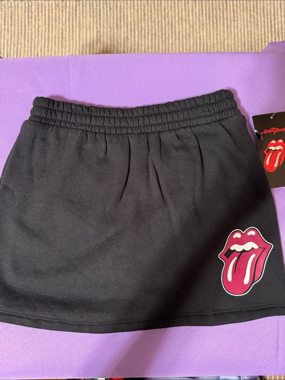 the Rolling Stones Black Mini Skirt with Pink Tongue Logo